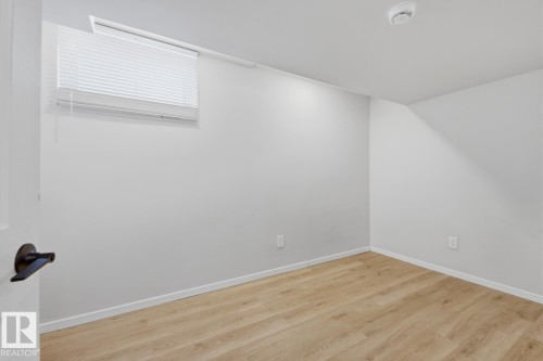 This room features light-colored walls and light wood-style flooring - 11332 134 Avenue, Edmonton, AB - Indoor Photo Showing Other Room