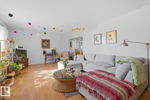 Living room with light wood-type flooring and a textured ceiling - 11332 134 Avenue, Edmonton, AB - Indoor Photo Showing Living Room