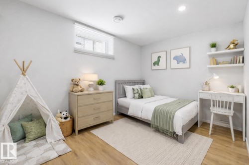 This space features light-colored walls, a window with blinds, and recessed lighting - 11332 134 Avenue, Edmonton, AB - Indoor Photo Showing Bedroom