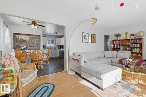 Living room featuring wood finished floors and a ceiling fan - 11332 134 Avenue, Edmonton, AB - Indoor Photo Showing Living Room