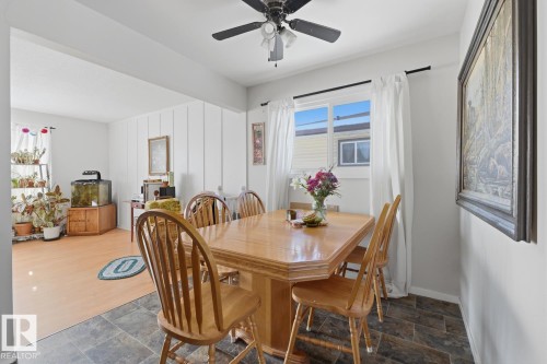 Dining room featuring stone finish floors and ceiling fan - 11332 134 Avenue, Edmonton, AB - Indoor Photo Showing Dining Room