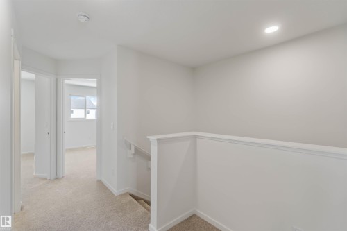 Hall with light carpet, an upstairs landing, and recessed lighting - 2467 Alces Link Link, Edmonton, AB - Indoor Photo Showing Other Room