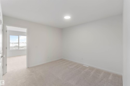 Unfurnished room featuring light colored carpet and baseboards - 2467 Alces Link Link, Edmonton, AB - Indoor Photo Showing Other Room
