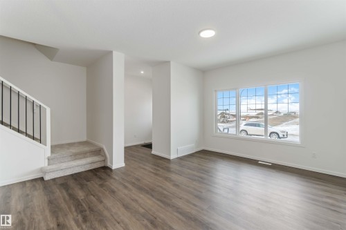 Unfurnished living room with dark wood-style floors and recessed lighting - 2467 Alces Link Link, Edmonton, AB - Indoor Photo Showing Other Room