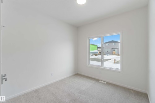 Empty room featuring light colored carpet and baseboards - 2467 Alces Link Link, Edmonton, AB - Indoor Photo Showing Other Room