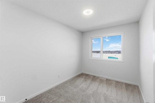 Empty room featuring baseboards and light carpet - 8652 Edgemont Link Link, Edmonton, AB - Indoor Photo Showing Other Room