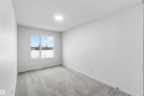 Spare room featuring light colored carpet and baseboards - 8652 Edgemont Link Link, Edmonton, AB - Indoor Photo Showing Other Room