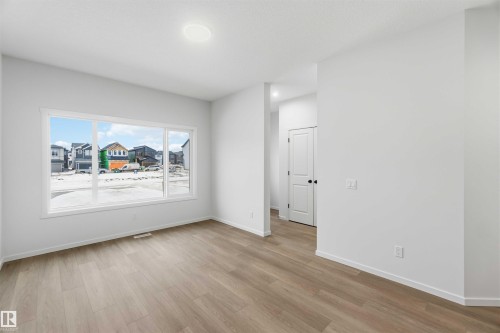 Spare room with light wood-style flooring and baseboards - 8652 Edgemont Link Link, Edmonton, AB - Indoor Photo Showing Other Room