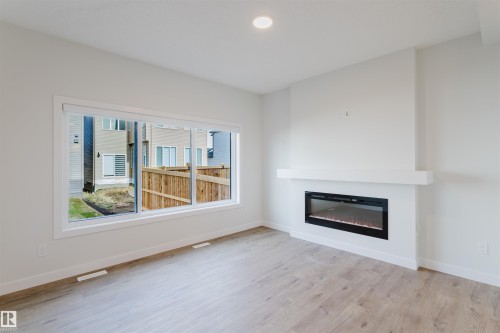 358 Bluff Cove, Leduc, AB - Indoor Photo Showing Living Room With Fireplace