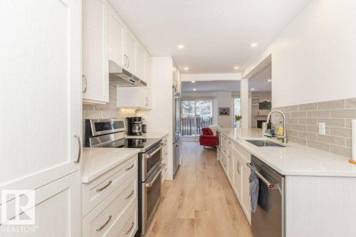 with glass tile back splash - 88 Hearthstone Nw, Edmonton, AB - Indoor Photo Showing Kitchen With Upgraded Kitchen