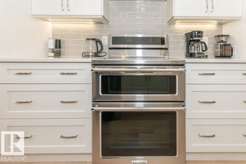 KitchenAid stove with induction cook top and double ovens - 88 Hearthstone Nw, Edmonton, AB - Indoor Photo Showing Kitchen With Upgraded Kitchen