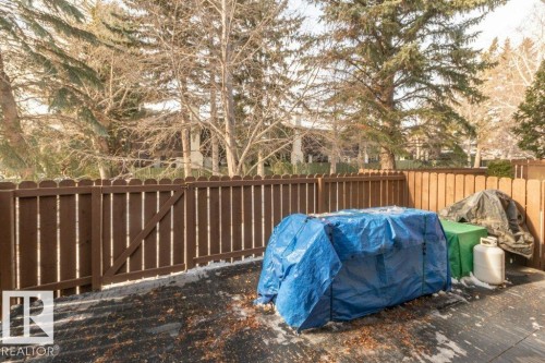 which is fenced in with a gate opening onto the green space behind - 88 Hearthstone Nw, Edmonton, AB - Outdoor