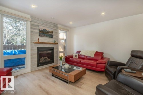 Living room featuring a fireplace and LED pot lights on dimmers - 88 Hearthstone Nw, Edmonton, AB - Indoor Photo Showing Living Room With Fireplace