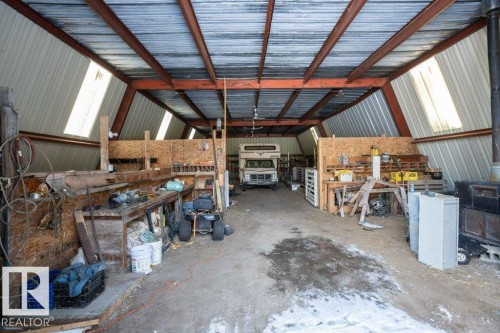 Garage with metal wall and a workshop area - 59415A Rg Rd 240, Rural Westlock County, AB - Indoor Photo Showing Garage