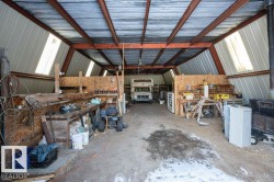 Garage with metal wall and a workshop area - 