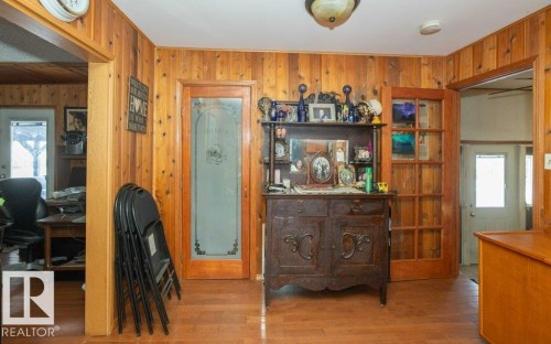Living area featuring plenty of natural light, wood finished floors, wood walls, and an office area - 59415A Rg Rd 240, Rural Westlock County, AB - Indoor Photo Showing Other Room