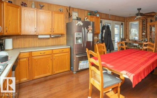 Dining room with light wood-style flooring, ceiling fan, and wooden walls - 59415A Rg Rd 240, Rural Westlock County, AB - Indoor
