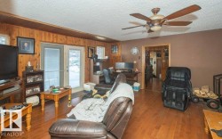 Living room with hardwood / wood-style flooring, a ceiling fan, an office area, a textured ceiling, and french doors - 