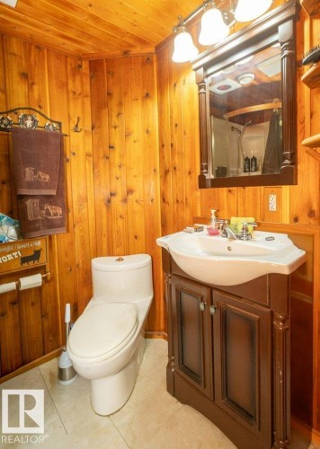 Bathroom featuring a shower with curtain, vanity, wood ceiling, and wooden walls - 59415A Rg Rd 240, Rural Westlock County, AB - Indoor Photo Showing Bathroom