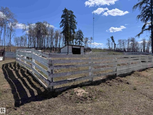 Expansive outdoor area featuring white-painted perimeter fencing and a barn structure - 59415A Rg Rd 240, Rural Westlock County, AB - Outdoor With View