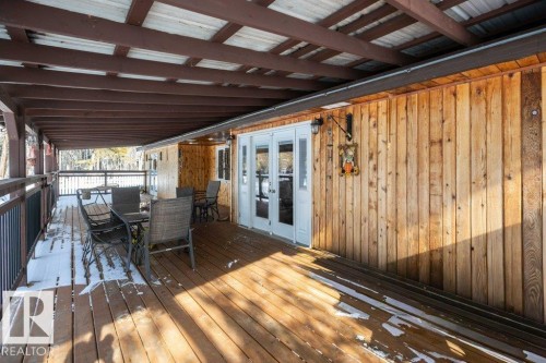 Wooden deck with french doors and outdoor dining area - 59415A Rg Rd 240, Rural Westlock County, AB -  With Deck Patio Veranda With Exterior