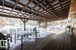 Snow covered deck with area for grilling, a patio area, and outdoor dining area - 