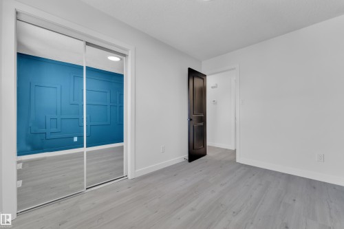 Unfurnished bedroom featuring a closet and light wood-style flooring - 8635 33 Avenue, Edmonton, AB - Indoor Photo Showing Other Room