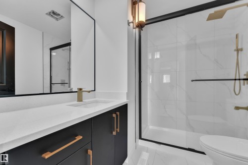 Full bathroom featuring vanity, a marble finish shower, and light marble finish flooring - 8635 33 Avenue, Edmonton, AB - Indoor Photo Showing Bathroom