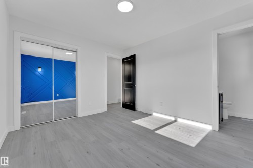 Unfurnished bedroom featuring light wood-type flooring and baseboards - 8635 33 Avenue, Edmonton, AB - Indoor Photo Showing Other Room