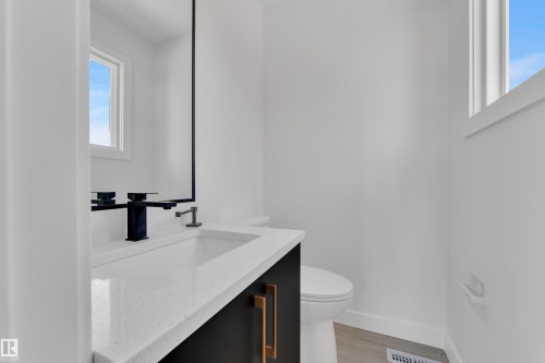 Bathroom featuring vanity and light wood-type flooring - 8635 33 Avenue, Edmonton, AB - Indoor Photo Showing Bathroom
