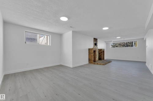Basement with light wood-style floors and baseboards - 8635 33 Avenue, Edmonton, AB - Indoor Photo Showing Other Room