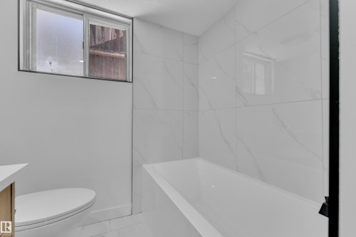 Full bath with vanity and a bath - 8635 33 Avenue, Edmonton, AB - Indoor Photo Showing Bathroom
