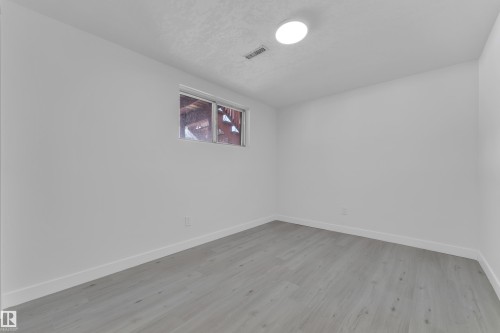Spare room featuring baseboards and light wood-style floors - 8635 33 Avenue, Edmonton, AB - Indoor Photo Showing Other Room