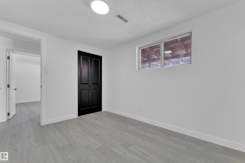 Unfurnished bedroom with a closet and light wood-type flooring - 8635 33 Avenue, Edmonton, AB - Indoor Photo Showing Other Room