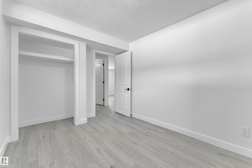 Unfurnished bedroom with a closet and light wood finished floors - 8635 33 Avenue, Edmonton, AB - Indoor Photo Showing Other Room