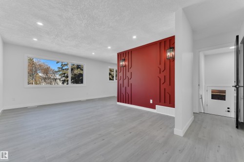 Empty room with recessed lighting, light wood finished floors, and a textured ceiling - 8635 33 Avenue, Edmonton, AB - Indoor Photo Showing Other Room
