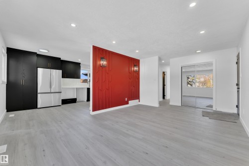 Unfurnished living room with light wood-style floors and recessed lighting - 8635 33 Avenue, Edmonton, AB - Indoor