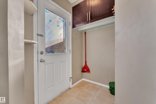 Doorway to outside featuring tile patterned flooring and baseboards - 6017 213 Street, Edmonton, AB - Indoor Photo Showing Other Room