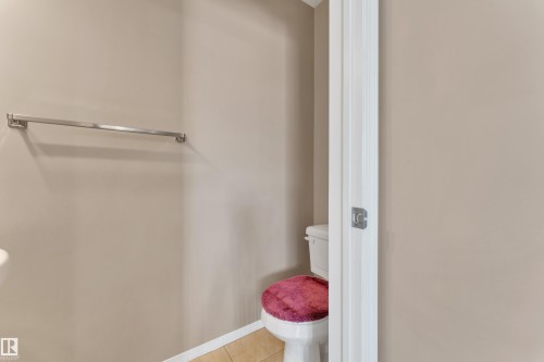 Bathroom with toilet and light tile patterned flooring - 6017 213 Street, Edmonton, AB - Indoor With Storage