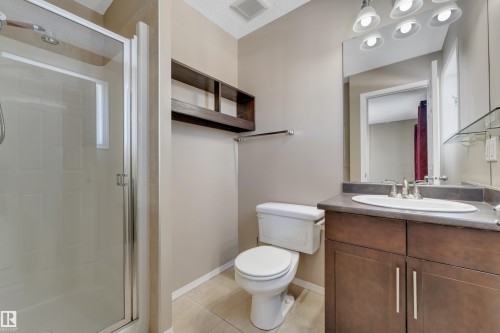 Bathroom featuring vanity, a shower stall, and light tile patterned floors - 6017 213 Street, Edmonton, AB - Indoor Photo Showing Bathroom