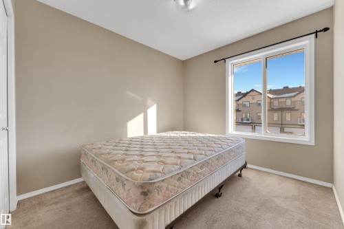 Bedroom with light colored carpet and baseboards - 6017 213 Street, Edmonton, AB - Indoor Photo Showing Bedroom