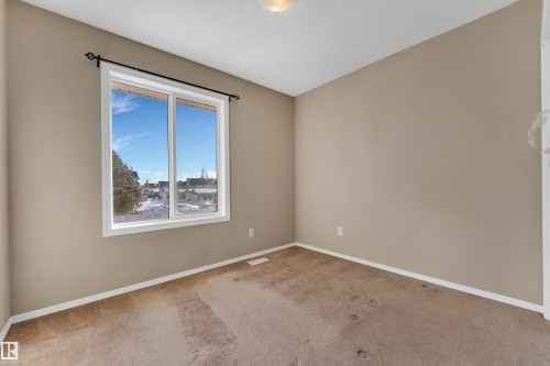 Spare room featuring carpet flooring and baseboards - 6017 213 Street, Edmonton, AB - Indoor Photo Showing Other Room