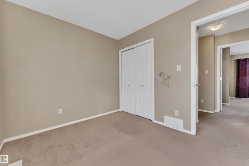 Unfurnished bedroom with light carpet and a closet - 6017 213 Street, Edmonton, AB - Indoor Photo Showing Other Room