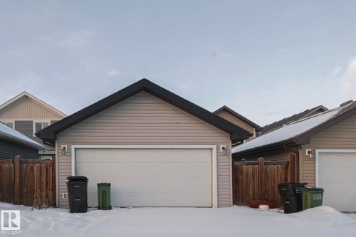 View of front facade featuring an outdoor structure and a garage - 21971 91 Avenue Nw, Edmonton, AB - Outdoor With Exterior