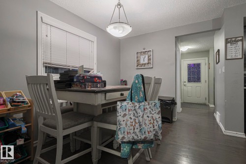 Office area with a textured ceiling and dark wood-style floors - 21971 91 Avenue Nw, Edmonton, AB - Indoor