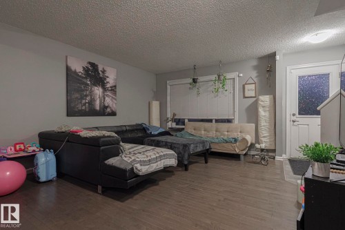 Living area featuring wood finished floors and a textured ceiling - 21971 91 Avenue Nw, Edmonton, AB - Indoor Photo Showing Living Room