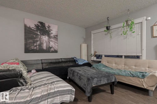 Living room featuring a textured ceiling and wood finished floors - 21971 91 Avenue Nw, Edmonton, AB - Indoor