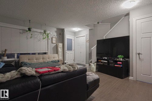 Living area featuring wood finished floors and a textured ceiling - 21971 91 Avenue Nw, Edmonton, AB - Indoor Photo Showing Other Room