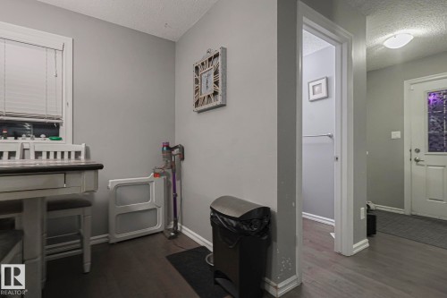Misc room featuring a textured ceiling and dark wood-style flooring - 21971 91 Avenue Nw, Edmonton, AB - Indoor