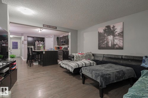 Living room with a textured ceiling and light wood-style floors - 21971 91 Avenue Nw, Edmonton, AB - Indoor Photo Showing Living Room